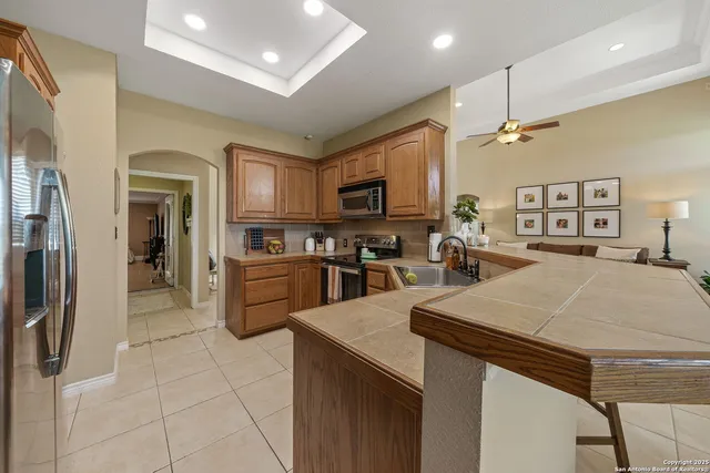 a kitchen with stainless steel appliances a refrigerator sink and microwave
