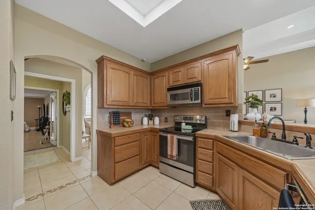 a kitchen with stainless steel appliances granite countertop a sink and cabinets