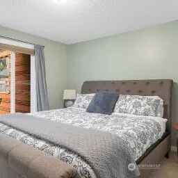 a bedroom with a large bed and a couch