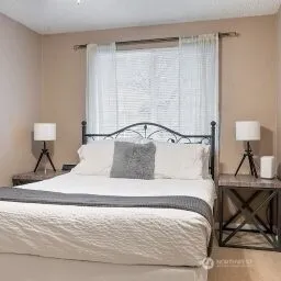 a bedroom with a bed and a table