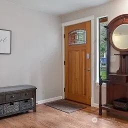 a view of an entryway with wooden floor