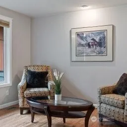 a living room with furniture and a potted plant