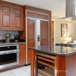 a kitchen with stainless steel appliances granite countertop a stove and a microwave