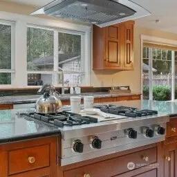 a kitchen with a stove and a white cabinets