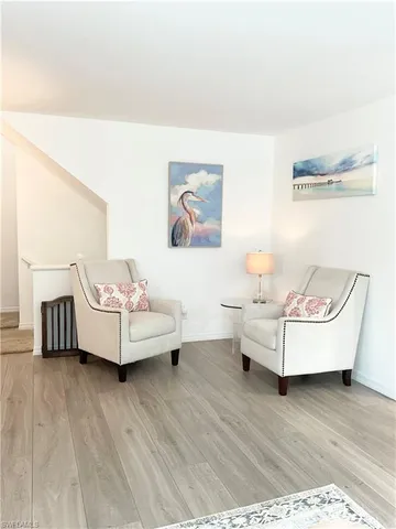 a view of a living room with furniture and flat screen tv