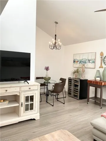 a view of a dining room with furniture and chandelier