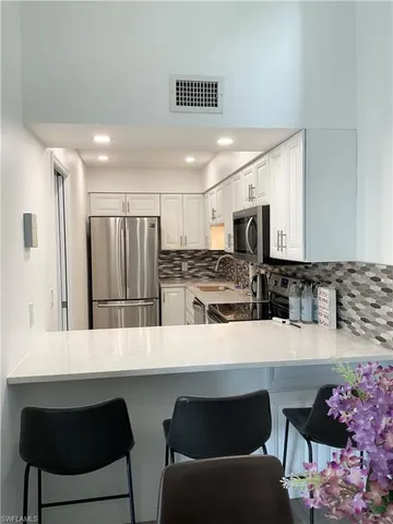 a kitchen with a cabinets and chandelier
