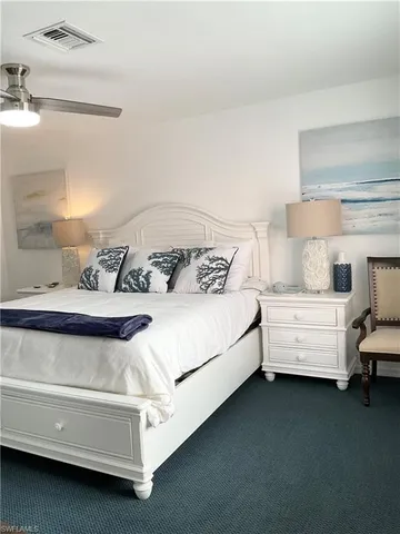 a bedroom with a bed and flat screen tv