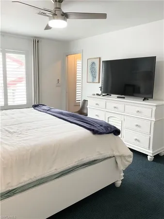 a spacious bedroom with a bed and a chandelier