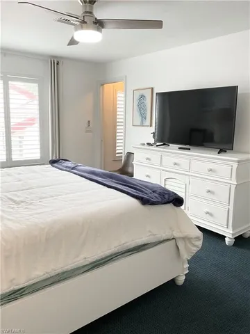 a spacious bedroom with a bed and a chandelier
