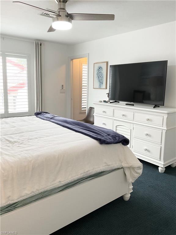 964 8th Avenue South, Unit B2 Naples, FL 34102 - Photo 21 of 37 a bedroom with a bed and flat screen tv