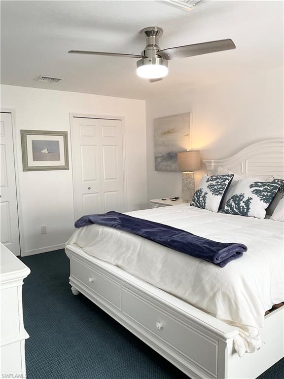 964 8th Avenue South, Unit B2 Naples, FL 34102 - Photo 22 of 37 a spacious bedroom with a bed and a chandelier