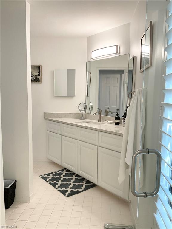 964 8th Avenue South, Unit B2 Naples, FL 34102 - Photo 25 of 37 a bathroom with a sink a toilet and mirror