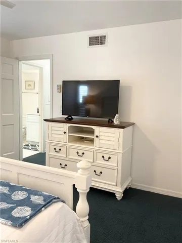 a bedroom with a bed and a night stand