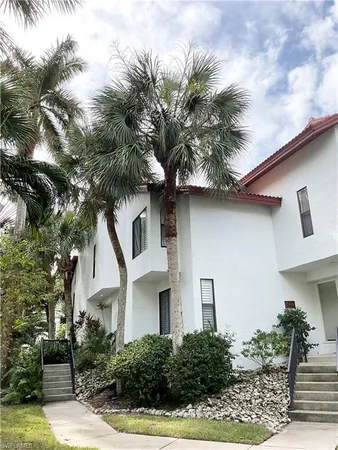 a view of a bedroom with wooden floor and windows
