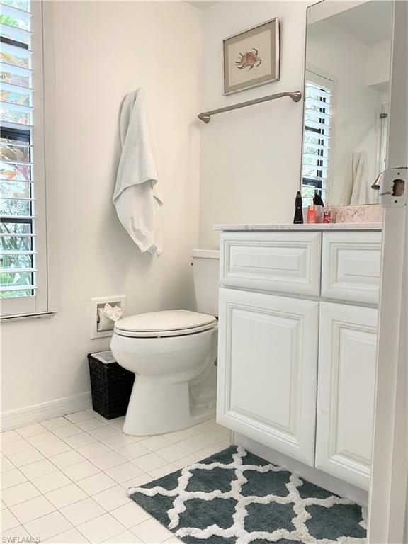 964 8th Avenue South, Unit B2 Naples, FL 34102 - Photo 33 of 37 a bathroom with a toilet and a mirror