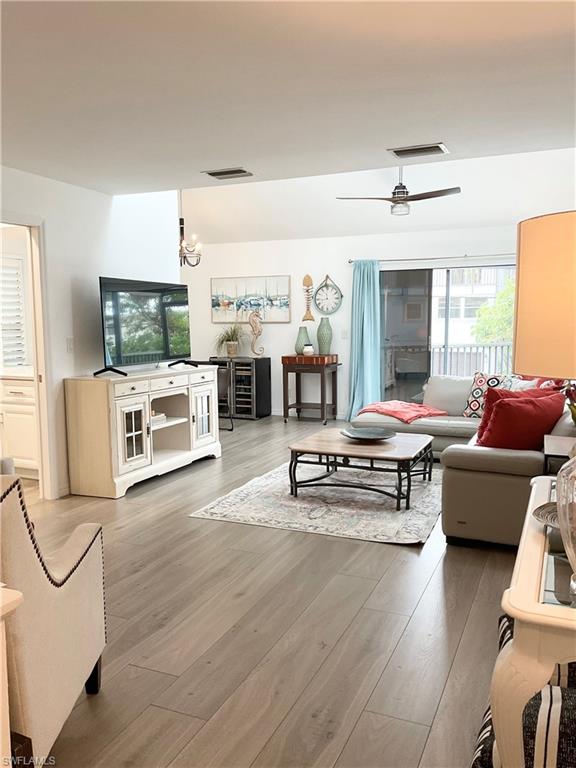 964 8th Avenue South, Unit B2 Naples, FL 34102 - Photo 7 of 37 a living room with furniture and a fireplace