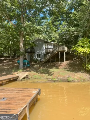 a swimming pool with outdoor seating and yard