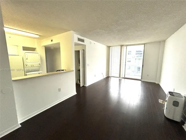 a view of a livingroom with wooden floor and a window