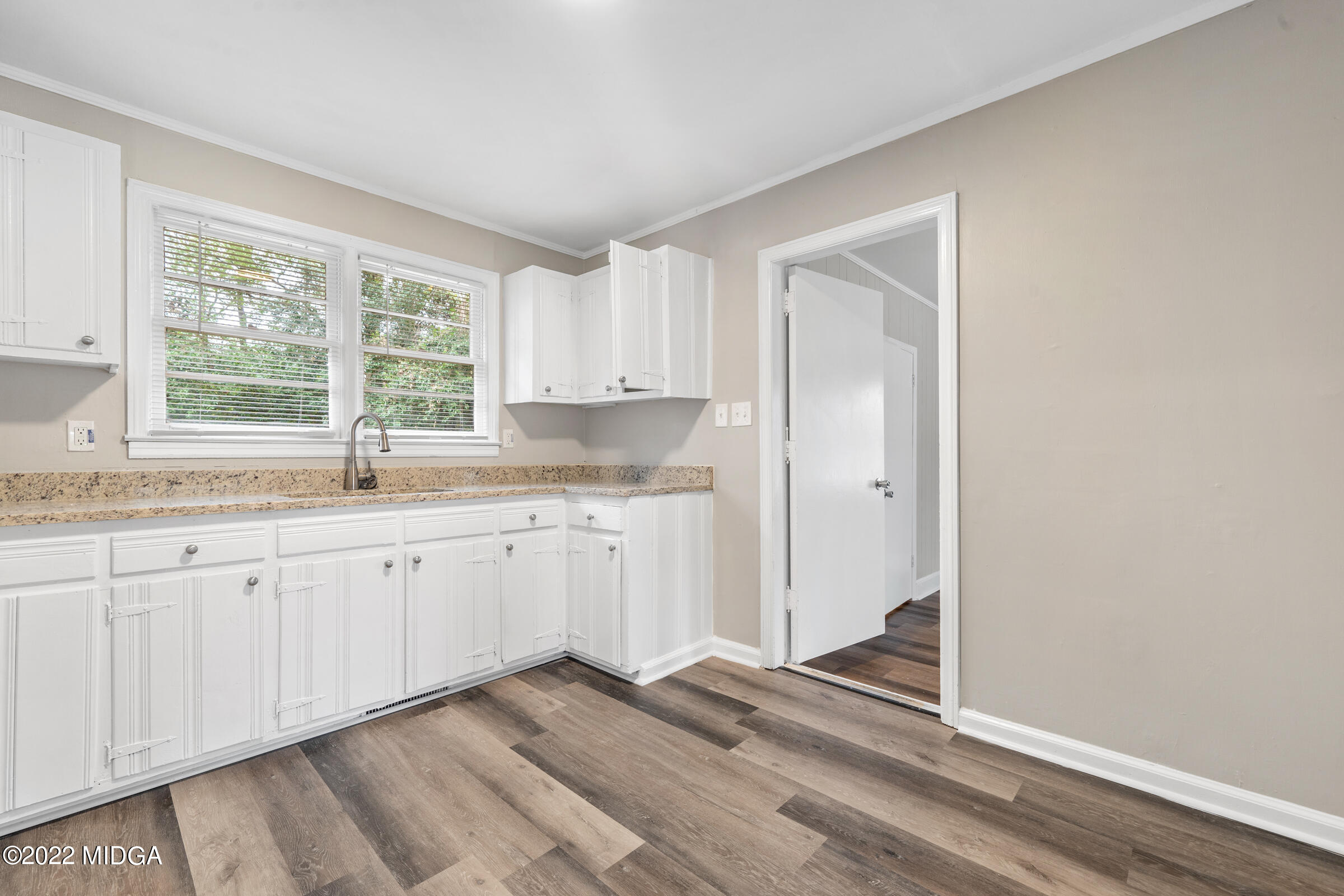 2225 Millerfield Road Macon, GA 31217 - Photo 7 of 21 a kitchen with granite countertop white cabinets and white appliances