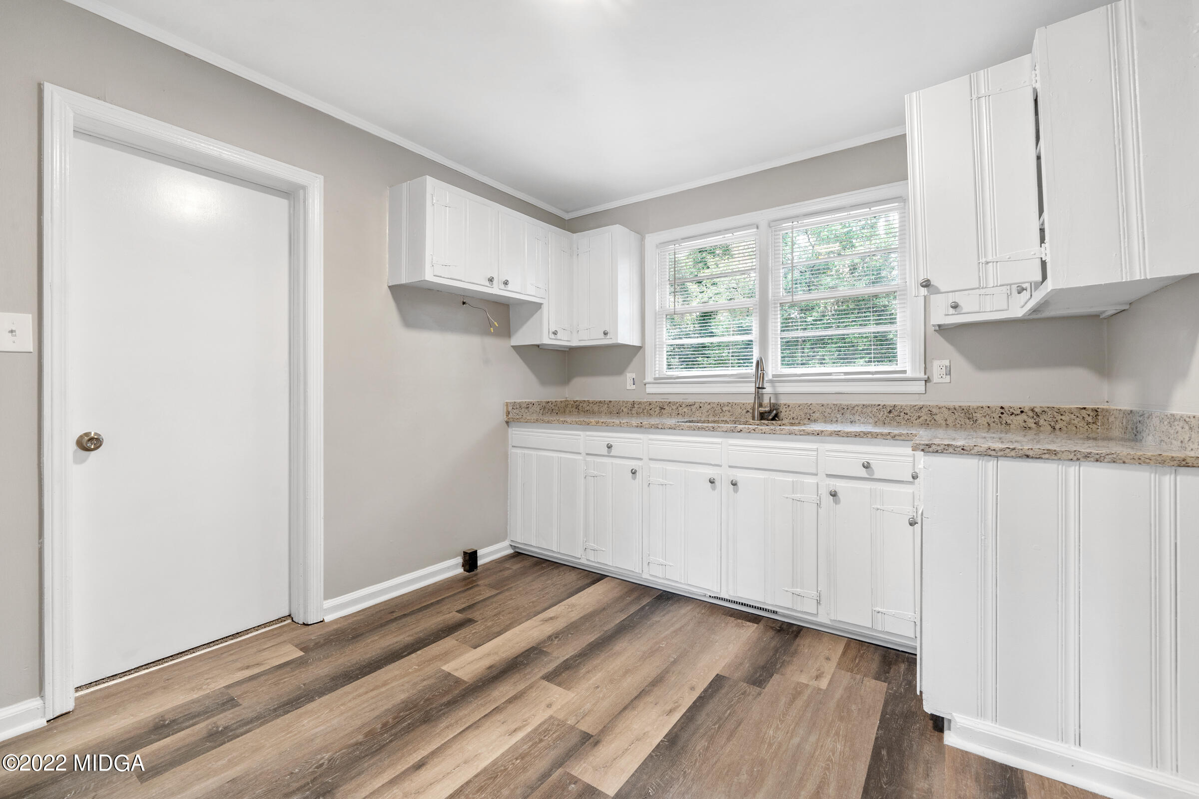 2225 Millerfield Road Macon, GA 31217 - Photo 8 of 21 a kitchen with granite countertop white cabinets and a window
