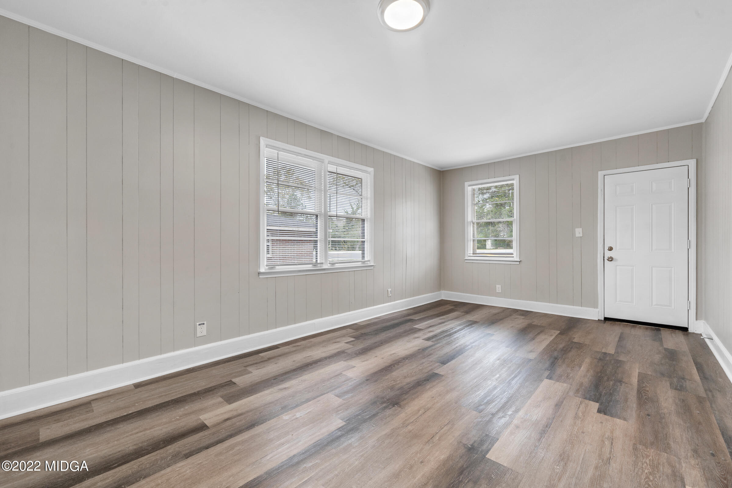 2225 Millerfield Road Macon, GA 31217 - Photo 10 of 21 an empty room with wooden floor and windows