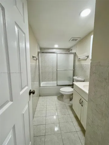 a bathroom with a glass door shower