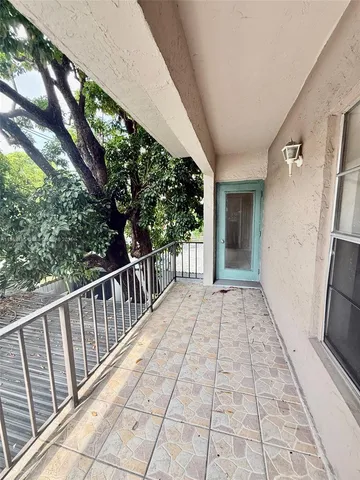a view of a porch with wooden floor and fence