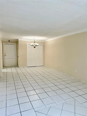 a view of a bedroom with a bed and a night stand