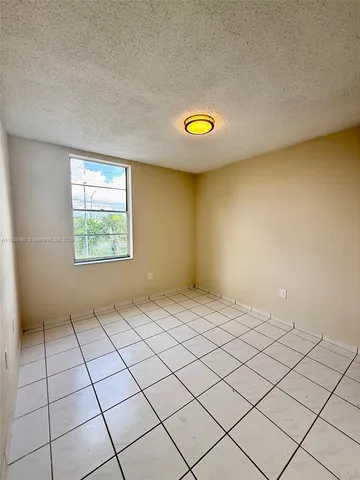 a view of an empty room and a window