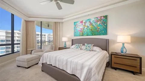 a bedroom with two beds and a chandelier