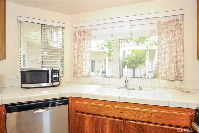 a kitchen with a sink and a large window