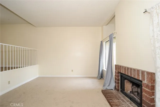 a view of an empty room with a fireplace