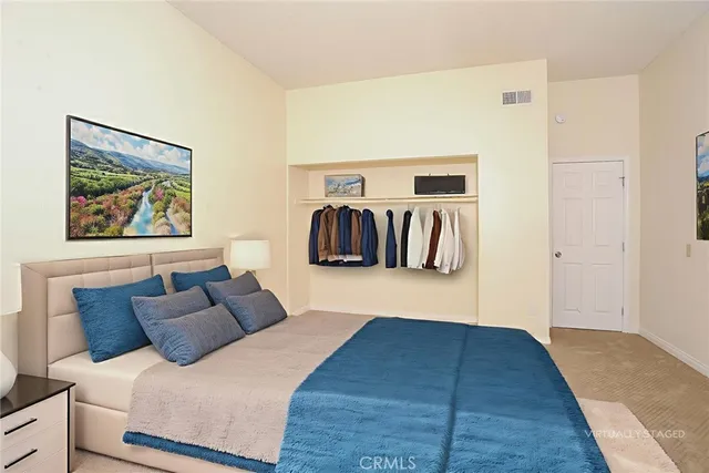 a bedroom with a bed and wall painting