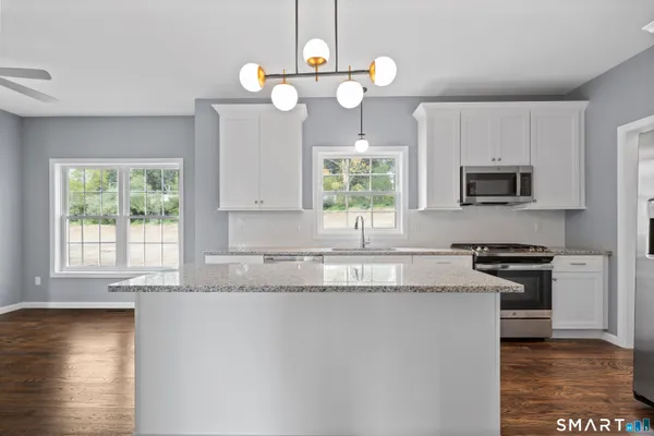 a view of a kitchen with wooden floor and a kitchen