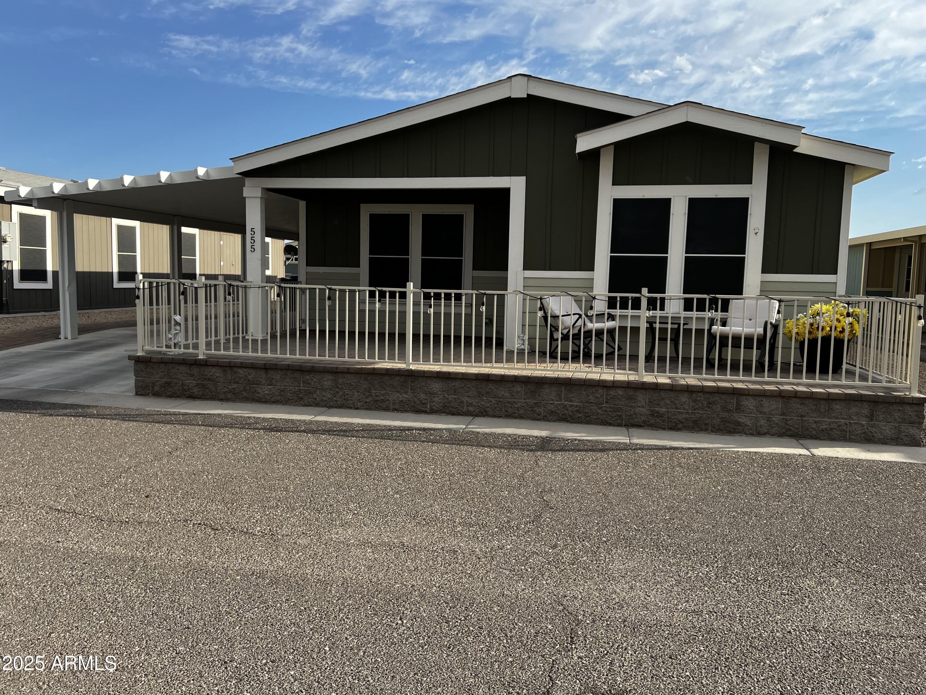 8865 East Baseline Road, Unit 555 Mesa, AZ 85209 - Photo 2 of 21 a view of a house with deck and a yard