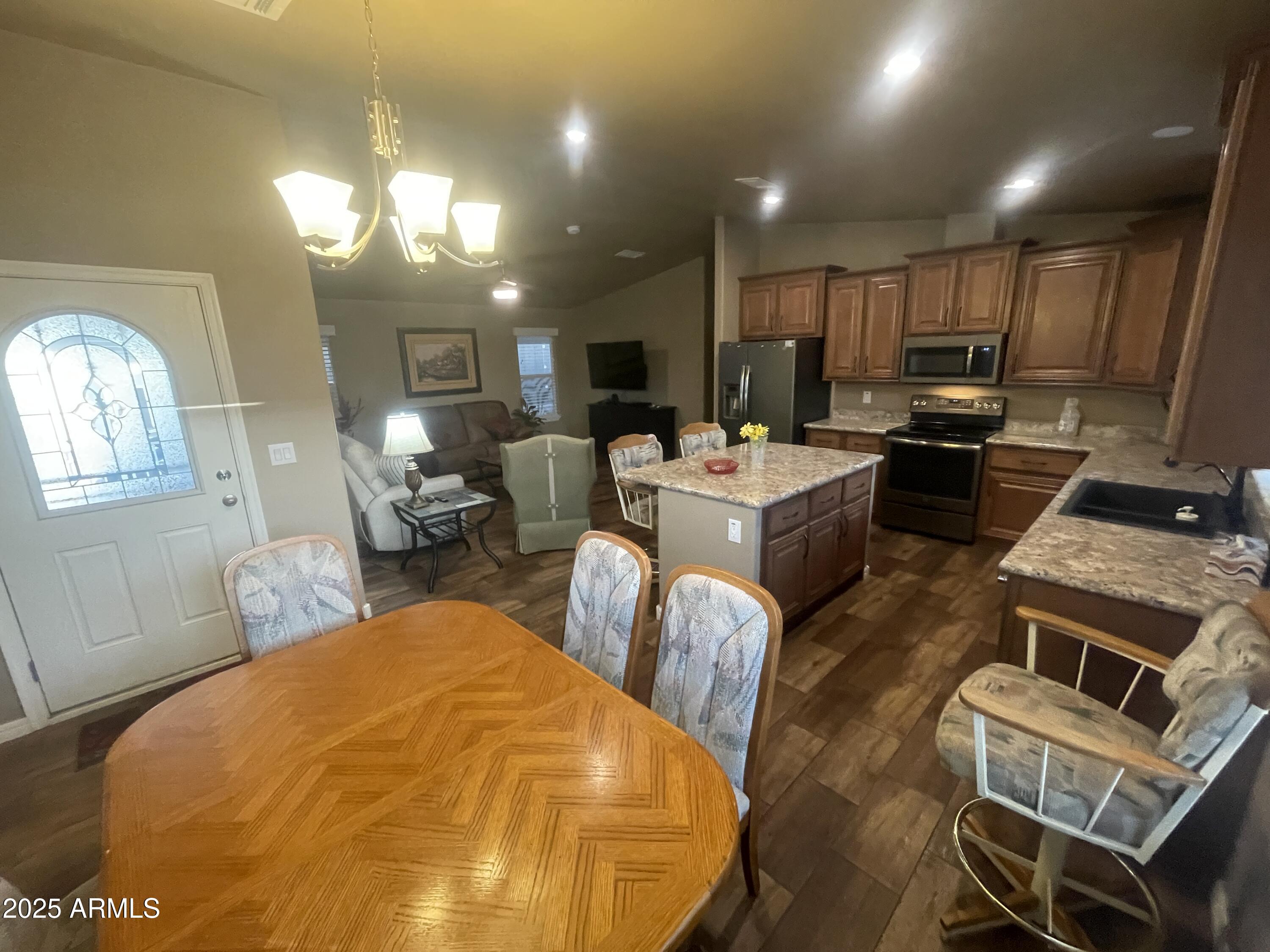 8865 East Baseline Road, Unit 555 Mesa, AZ 85209 - Photo 4 of 21 a living room with fireplace furniture and a flat screen tv