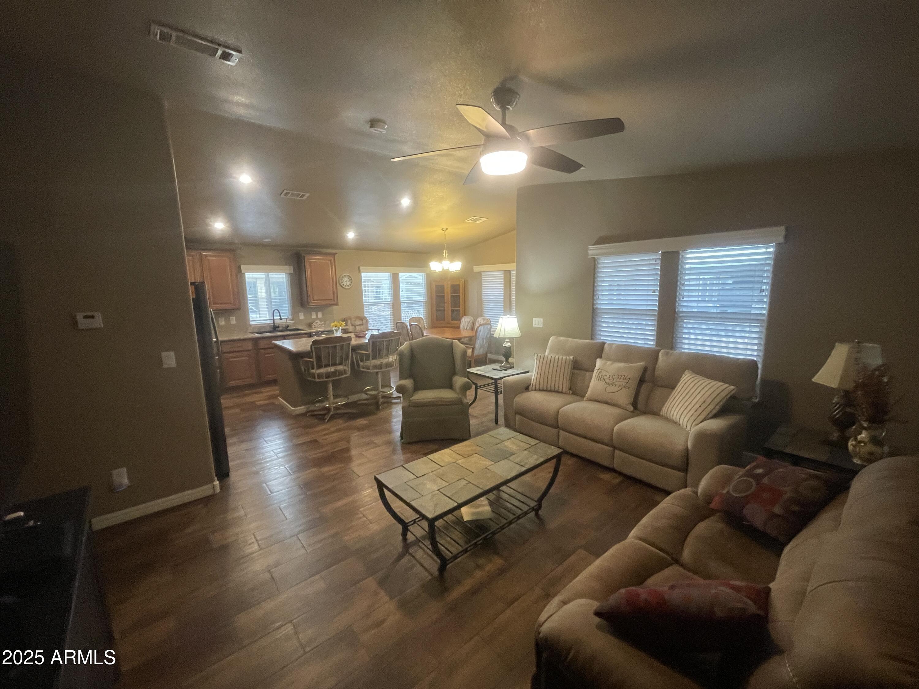 8865 East Baseline Road, Unit 555 Mesa, AZ 85209 - Photo 7 of 21 a living room with furniture and a chandelier