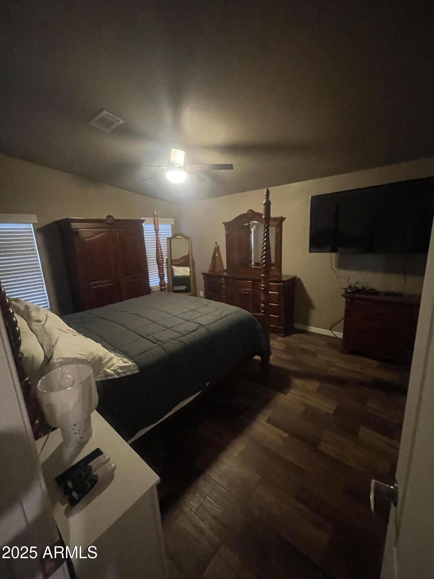 8865 East Baseline Road, Unit 555 Mesa, AZ 85209 - Photo 8 of 21 a spacious bedroom with a bed and a television