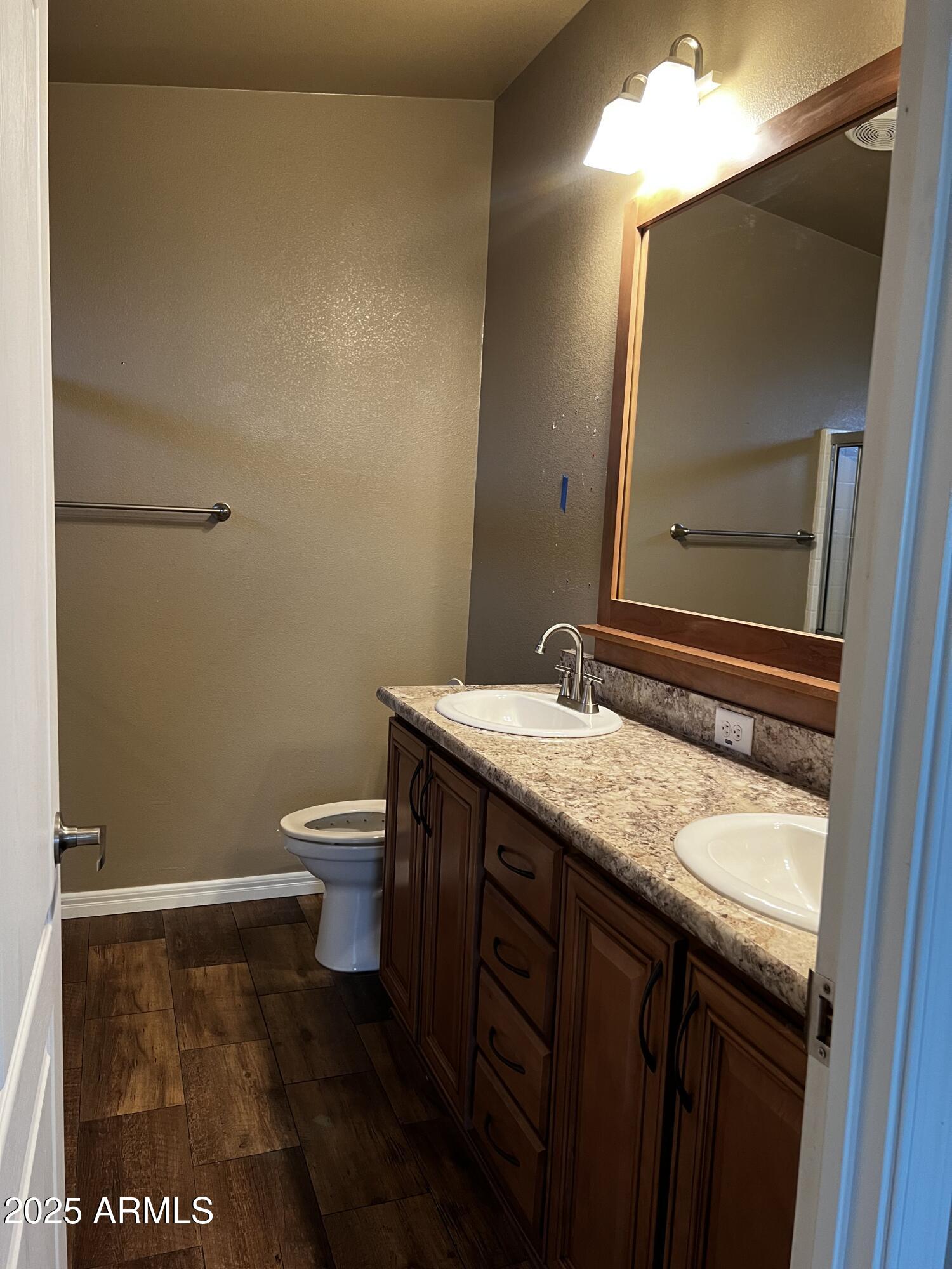 8865 East Baseline Road, Unit 555 Mesa, AZ 85209 - Photo 10 of 21 a bathroom with a granite countertop sink and a toilet