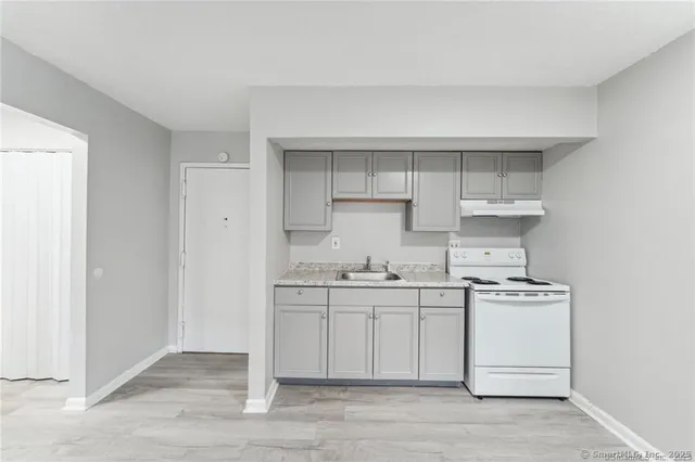 a kitchen with stainless steel appliances a sink stove and cabinets