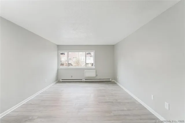 a view of an empty room and a window