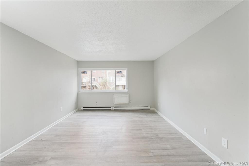 1150 Ogden St Extension, Unit 208 Bridgeport, CT 06610 - Photo 6 of 7 a view of an empty room and a window