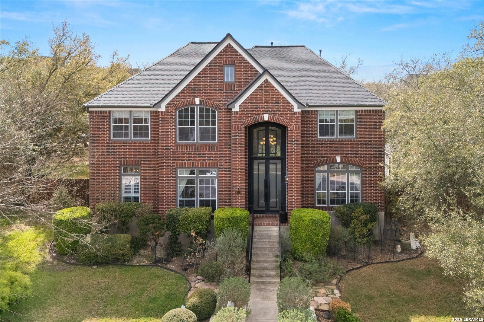 8718 Timberland Trail Fair Oaks Ranch, TX 78015 - Photo 1 of 50 a front view of a house with a yard