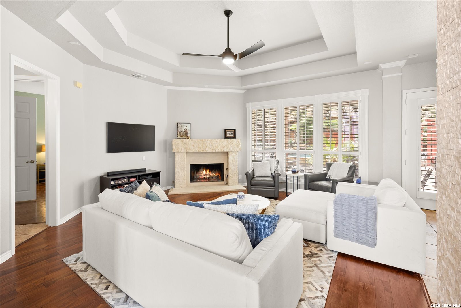 8718 Timberland Trail Fair Oaks Ranch, TX 78015 - Photo 12 of 50 a living room with furniture a fireplace and a flat screen tv
