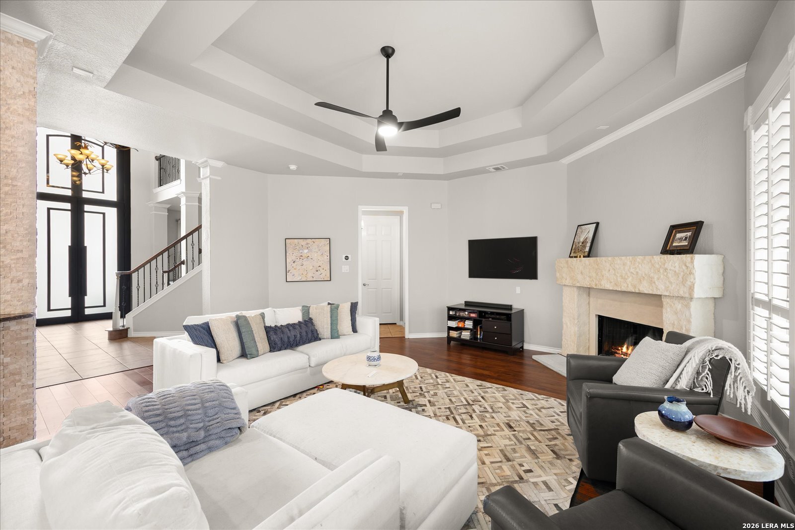 8718 Timberland Trail Fair Oaks Ranch, TX 78015 - Photo 13 of 50 a living room with furniture a fireplace and a flat screen tv