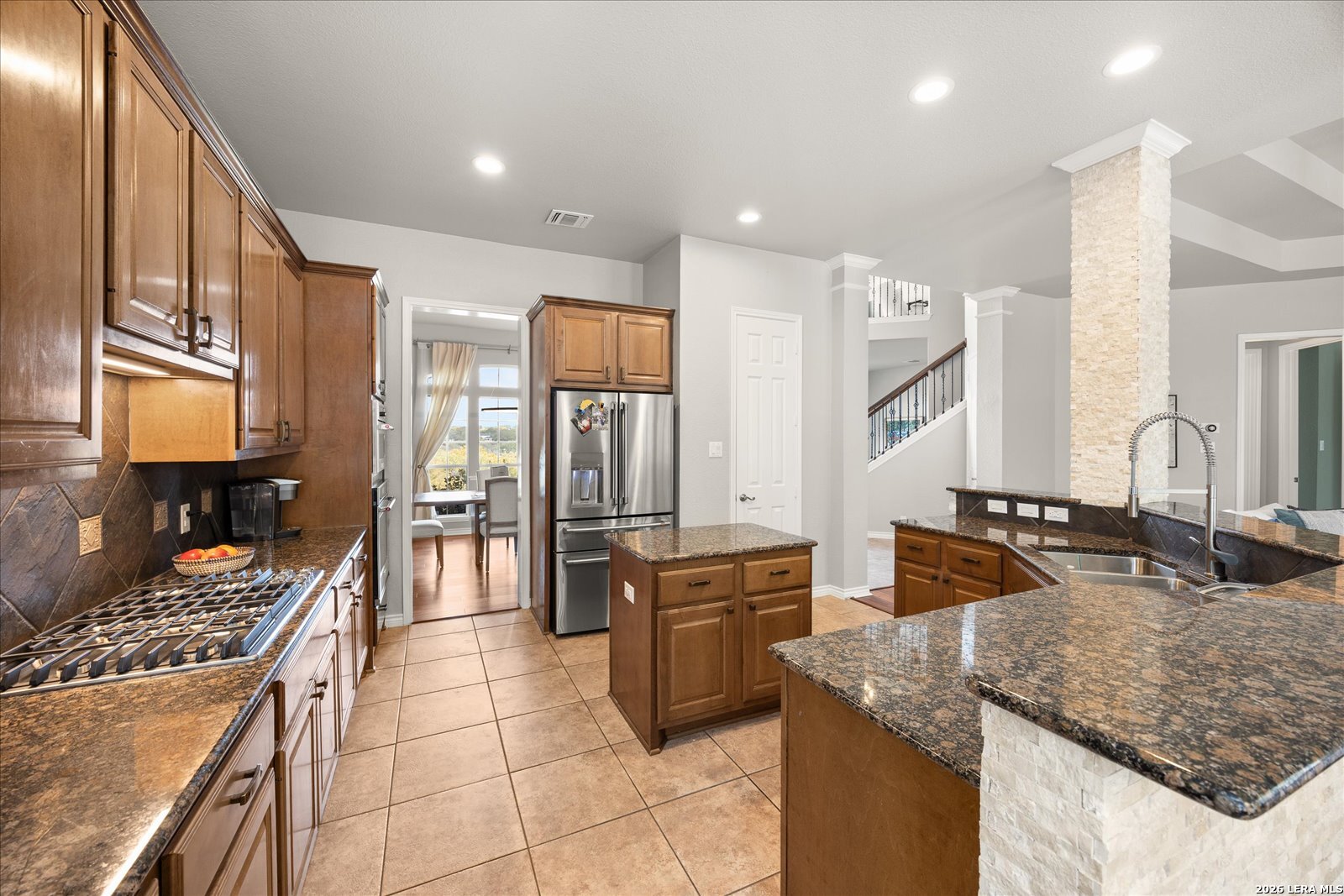 8718 Timberland Trail Fair Oaks Ranch, TX 78015 - Photo 17 of 50 a kitchen with stainless steel appliances granite countertop a sink stove and refrigerator