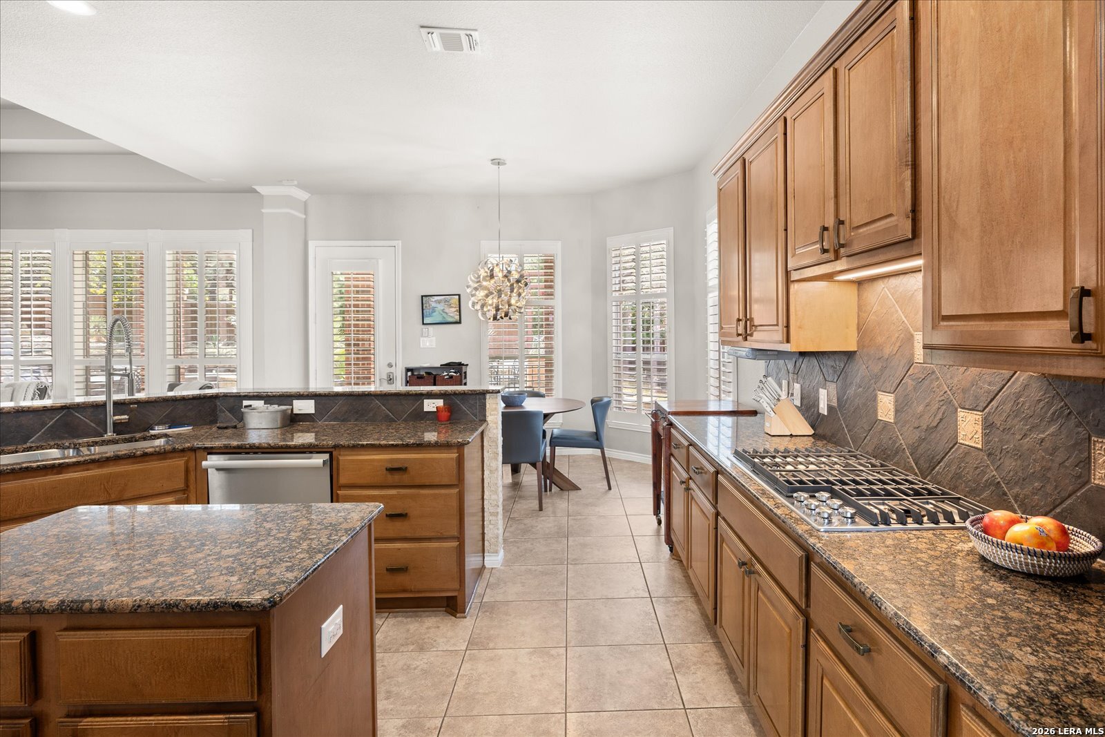 8718 Timberland Trail Fair Oaks Ranch, TX 78015 - Photo 18 of 50 a kitchen with a stove a sink and a refrigerator