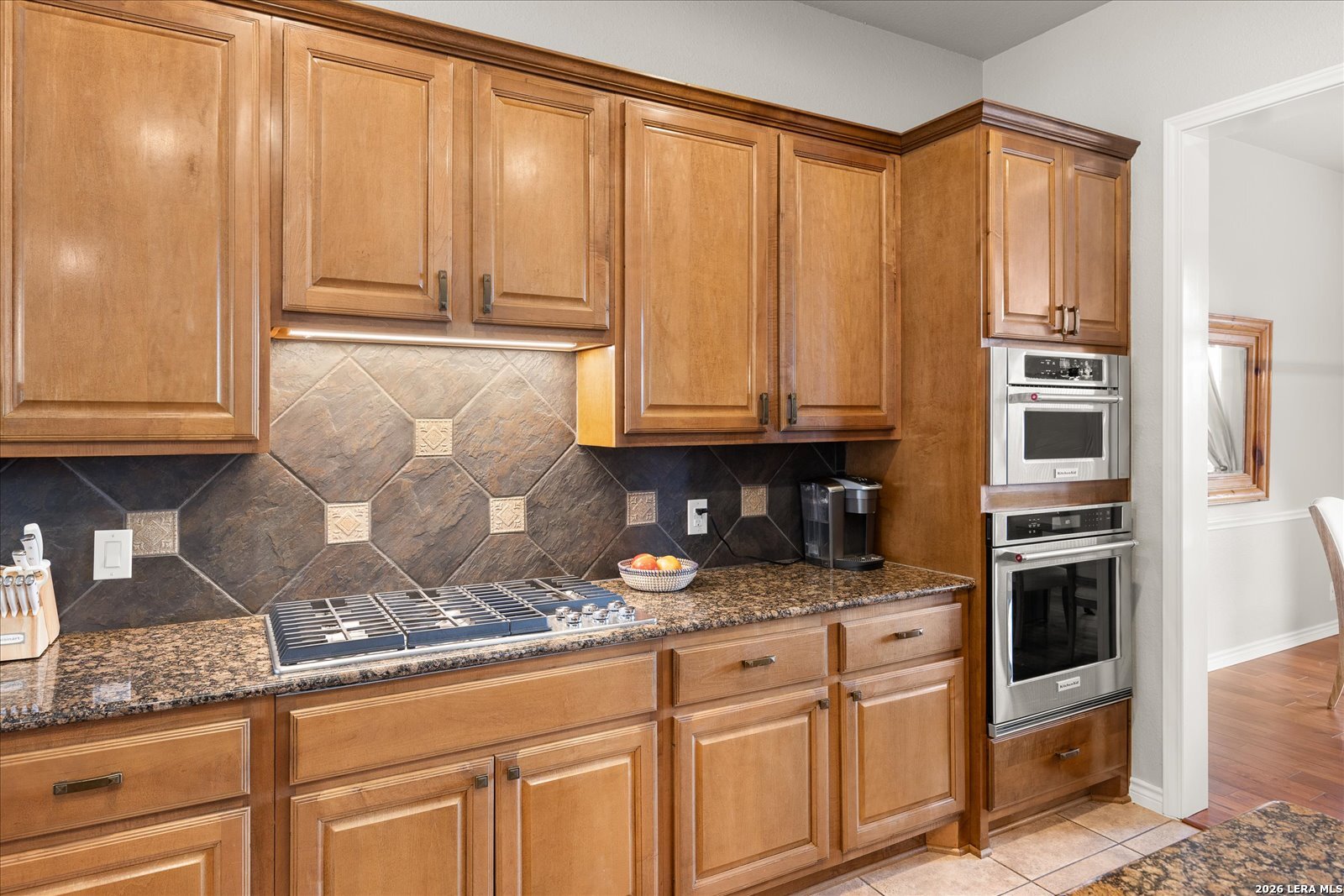 8718 Timberland Trail Fair Oaks Ranch, TX 78015 - Photo 19 of 50 a kitchen with stainless steel appliances granite countertop white cabinets and white appliances