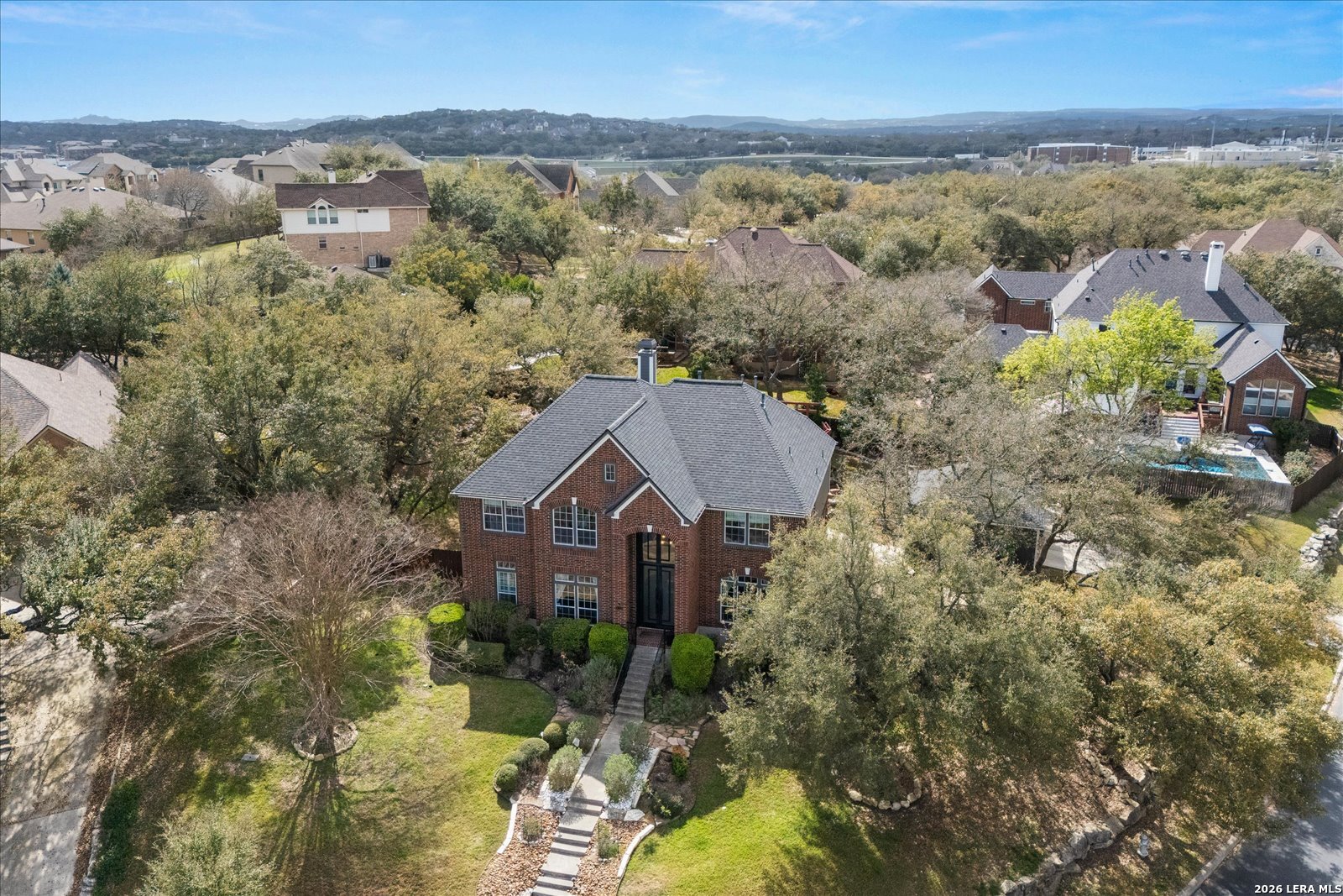 8718 Timberland Trail Fair Oaks Ranch, TX 78015 - Photo 3 of 50 an aerial view of a house with a yard and lake view